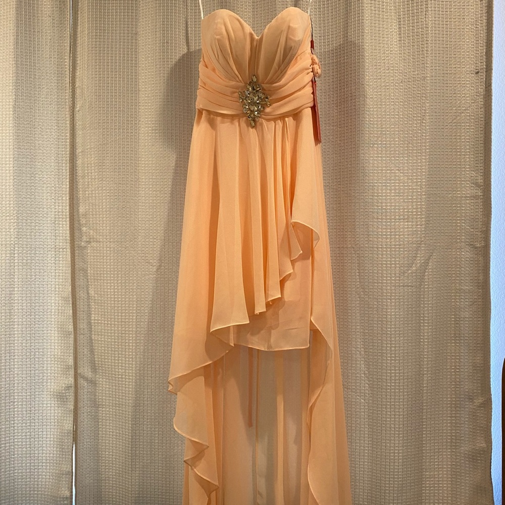 color is more of a soft peach. Never worn.